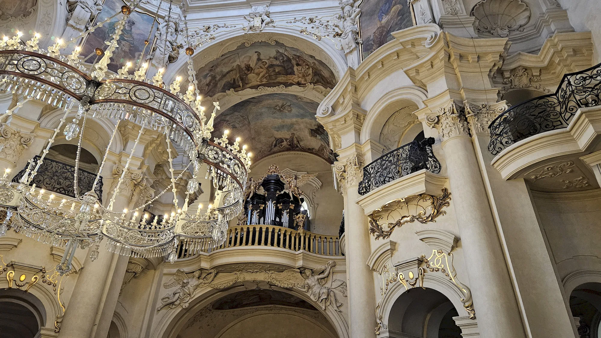 Pipe organ and balcony inside the baroque interior of Kostel sv. Mikuláše in Prague