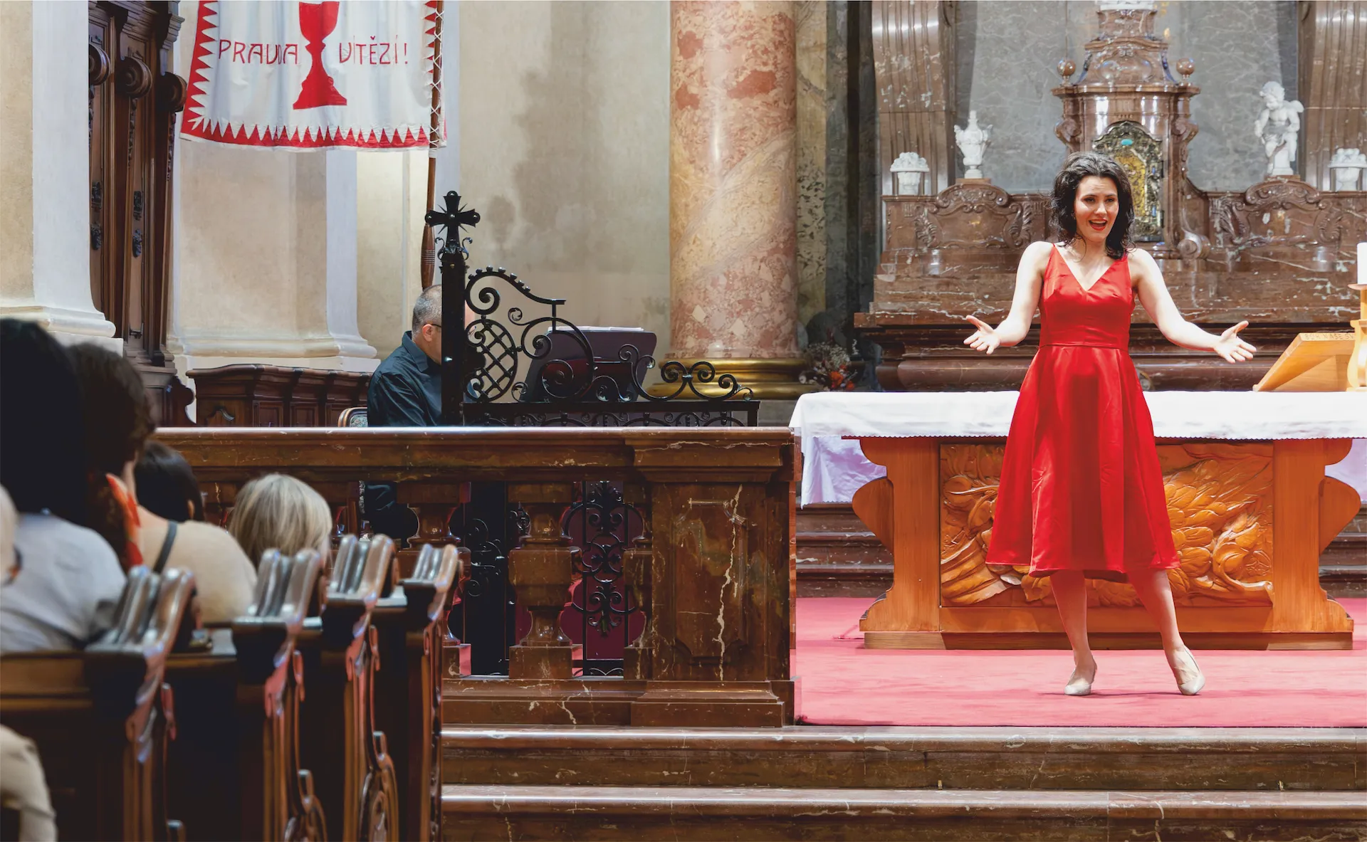 Soprano Zuzana Koś Kopřivová performing close to the audience in Kostel sv. Mikuláše
