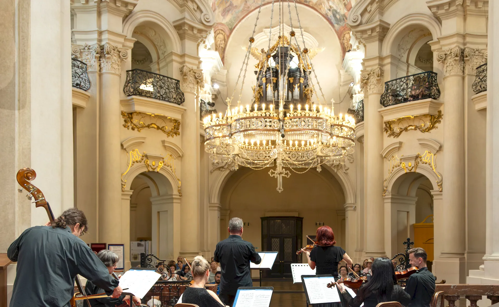 National Chamber Orchestra performing beneath the chandelier in Kostel sv. Mikuláše