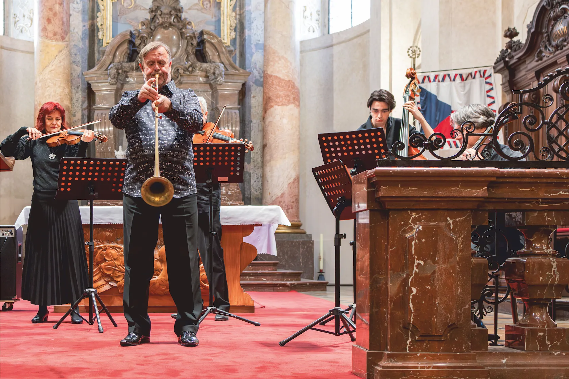 Trumpet soloist performing with Prague Concert Orchestra inside Kostel sv. Mikuláše